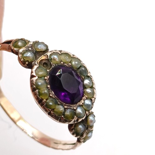 785 - A 19th century yellow metal, seed pearl and amethyst stone ring, ring size M