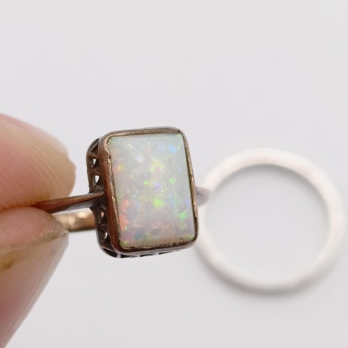 784 - A yellow coloured metal and opal ring, ring size D, and a platinum wedding band, ring size I 1/2 (2)