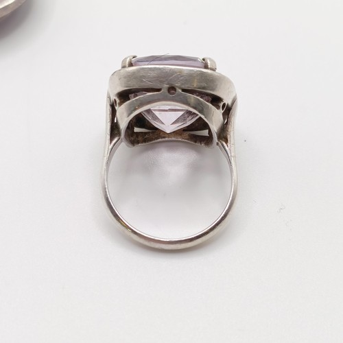 772 - A silver coloured metal, white stone and amethyst brooch, and a similar ring (2)