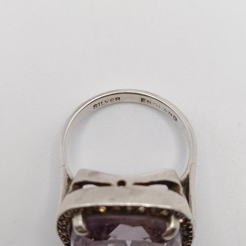 772 - A silver coloured metal, white stone and amethyst brooch, and a similar ring (2)