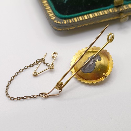 744 - A yellow coloured metal, seed pearl and purple stone bar brooch, in a vintage jewellery box