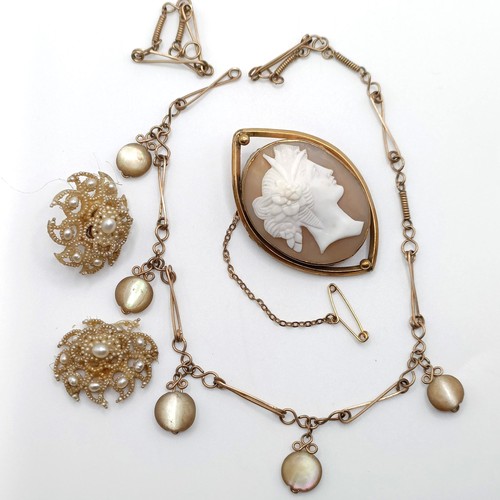 701 - An early 20th century cameo, in a yellow metal mount, a yellow metal chain, and a pair of seed pearl... 