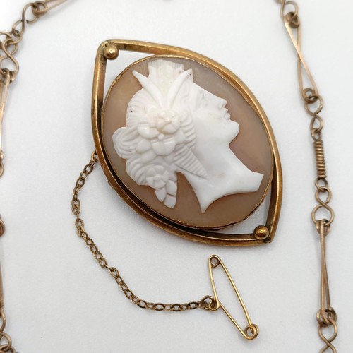 701 - An early 20th century cameo, in a yellow metal mount, a yellow metal chain, and a pair of seed pearl... 