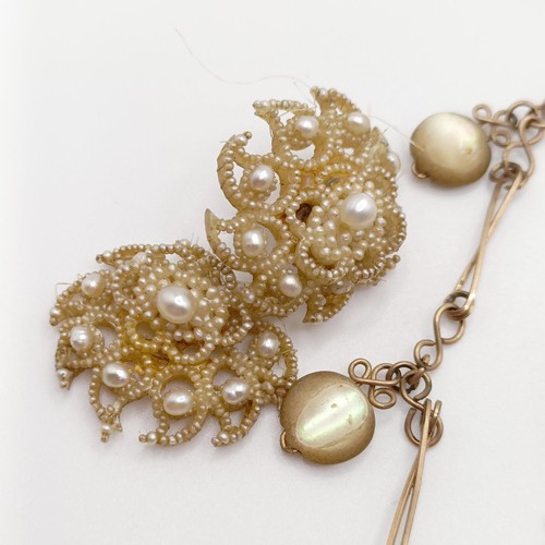 701 - An early 20th century cameo, in a yellow metal mount, a yellow metal chain, and a pair of seed pearl... 