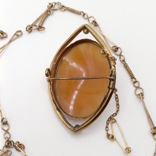 701 - An early 20th century cameo, in a yellow metal mount, a yellow metal chain, and a pair of seed pearl... 