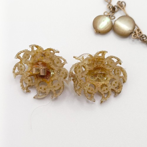 701 - An early 20th century cameo, in a yellow metal mount, a yellow metal chain, and a pair of seed pearl... 