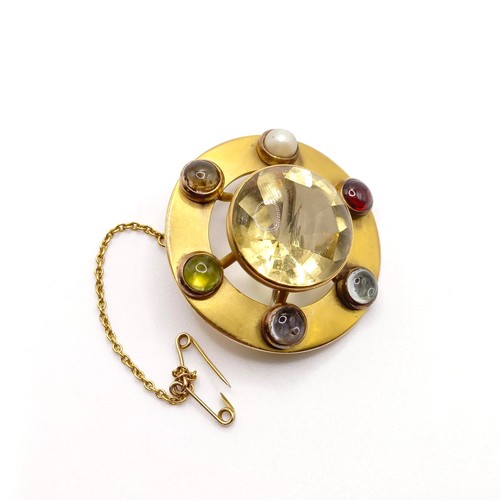 689 - A late 19th/early 20th century yellow coloured metal and multi-coloured stone brooch