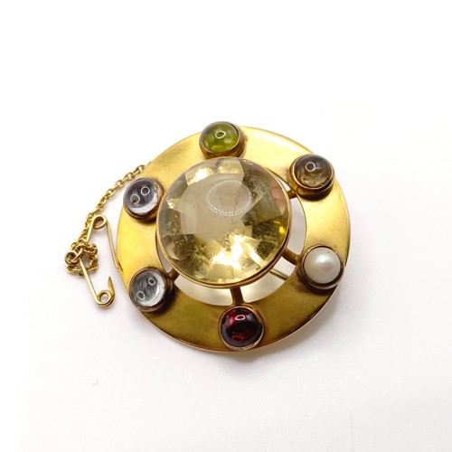 689 - A late 19th/early 20th century yellow coloured metal and multi-coloured stone brooch