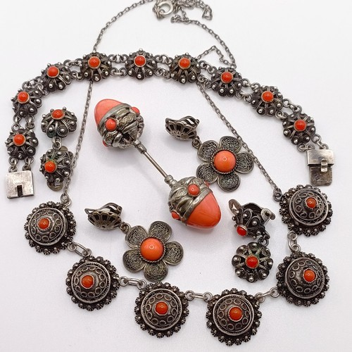 670 - An early 20th century silver coloured metal and coral necklace, a similar necklace, two pairs of ear... 