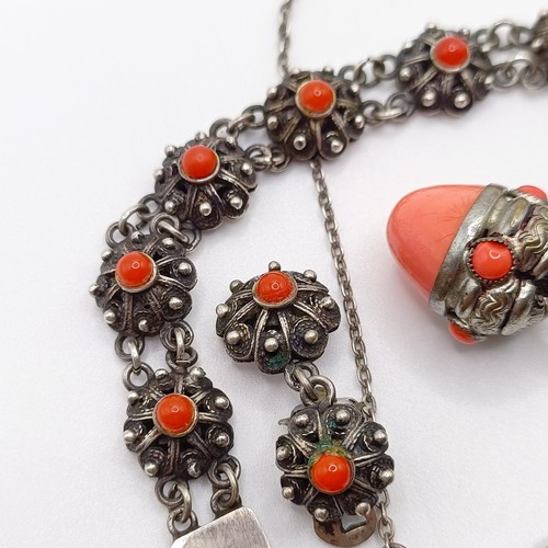 670 - An early 20th century silver coloured metal and coral necklace, a similar necklace, two pairs of ear... 