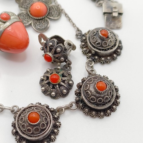 670 - An early 20th century silver coloured metal and coral necklace, a similar necklace, two pairs of ear... 