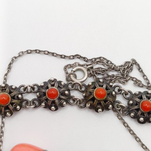 670 - An early 20th century silver coloured metal and coral necklace, a similar necklace, two pairs of ear... 