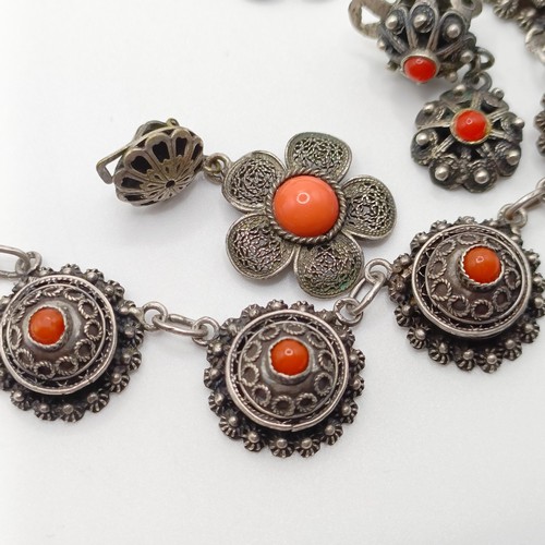 670 - An early 20th century silver coloured metal and coral necklace, a similar necklace, two pairs of ear... 