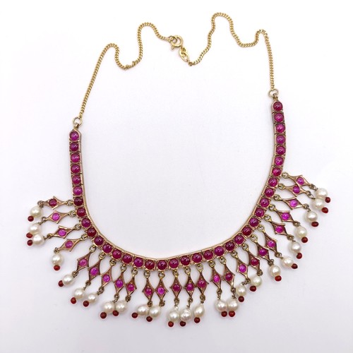 916 - An Indian gold and cabochon cut ruby and pearl fringe necklace