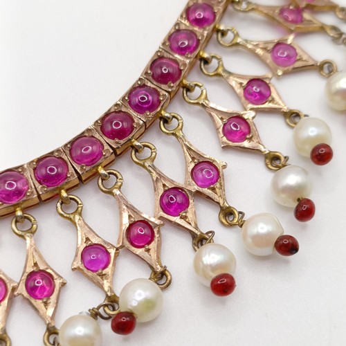 916 - An Indian gold and cabochon cut ruby and pearl fringe necklace