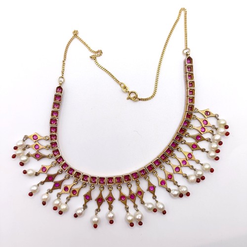 916 - An Indian gold and cabochon cut ruby and pearl fringe necklace