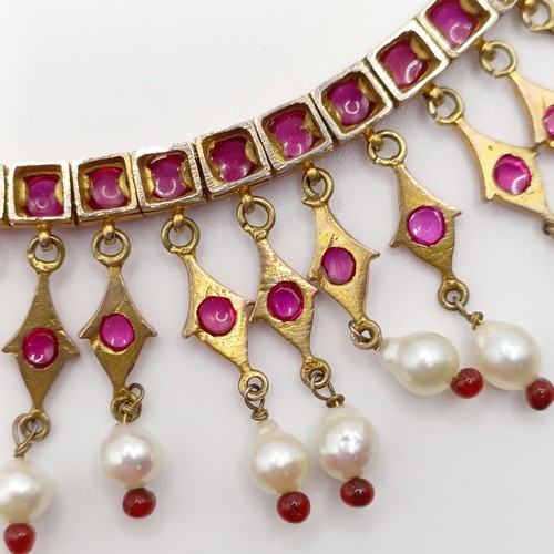 916 - An Indian gold and cabochon cut ruby and pearl fringe necklace