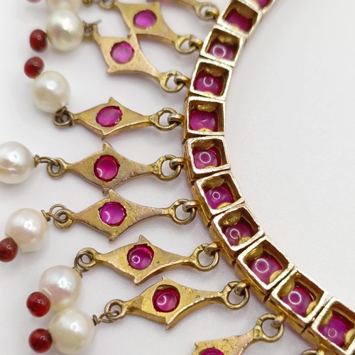 916 - An Indian gold and cabochon cut ruby and pearl fringe necklace