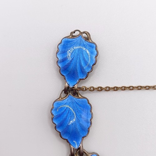 948 - A silver coloured metal and blue enamel bracelet, the links in the form of leaves