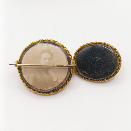 949 - A late 19th/early 20th century yellow metal cabochon cut red stone and diamond brooch, and a matchin... 