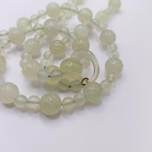 973 - A Chinese light greenstone necklace, and a bead necklace (2)