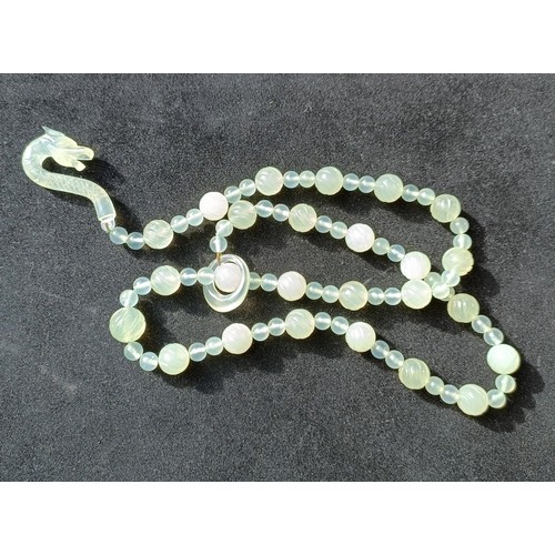 973 - A Chinese light greenstone necklace, and a bead necklace (2)