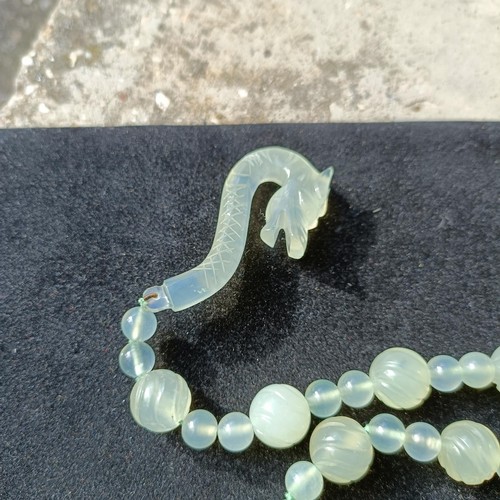 973 - A Chinese light greenstone necklace, and a bead necklace (2)