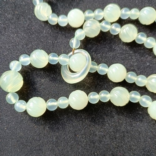 973 - A Chinese light greenstone necklace, and a bead necklace (2)