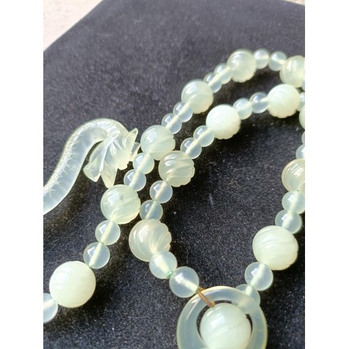 973 - A Chinese light greenstone necklace, and a bead necklace (2)