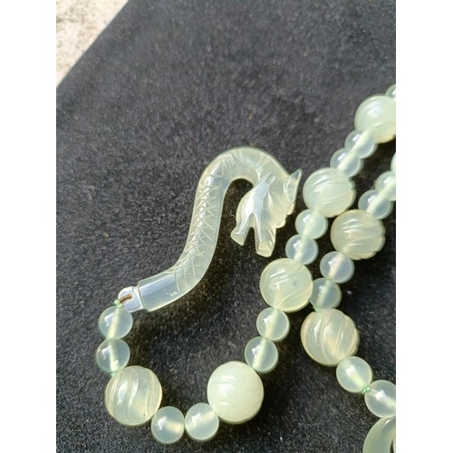 973 - A Chinese light greenstone necklace, and a bead necklace (2)