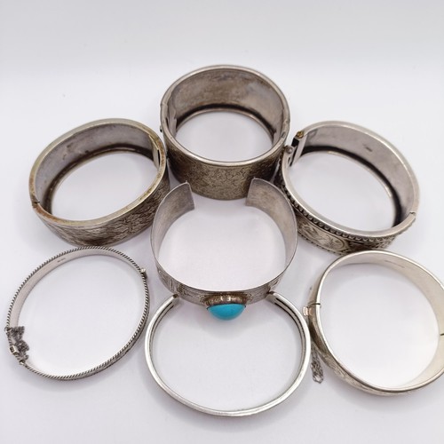 990 - A silver bangle, and six others (7)