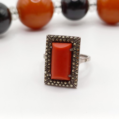 992 - An Art Deco silver, coral and marcasite panel ring, ring size S, the setting with a pierced back, an... 