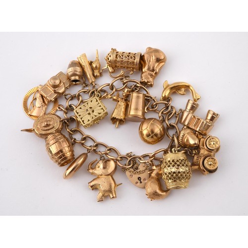 698 - A 9ct gold charm bracelet, with assorted gold and yellow metal charms, all in 52.5g