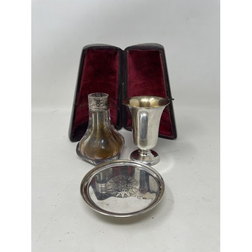 1372 - A late 19th/early 20th century silver plated communion set, comprising a cup, glass bottle, and a tr... 