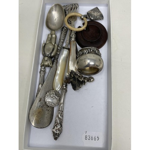 1206 - A George V silver mug, a silver coloured metal baby's rattle, in the form of a bear, assorted flatwa... 