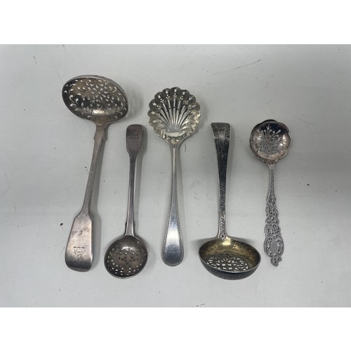 1376 - A Victorian silver Old English pattern sifter spoon, and four other sifter spoons, various dates and... 