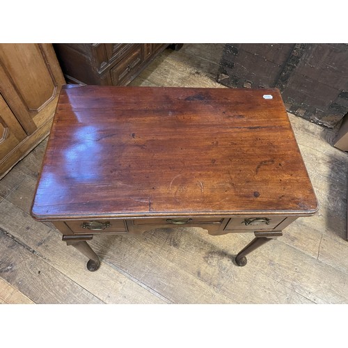 1643 - A 19th century mahogany lowboy, with three drawers, on tapering legs and pad feet, 76 cm wide