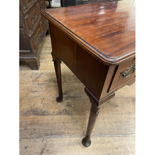 1643 - A 19th century mahogany lowboy, with three drawers, on tapering legs and pad feet, 76 cm wide