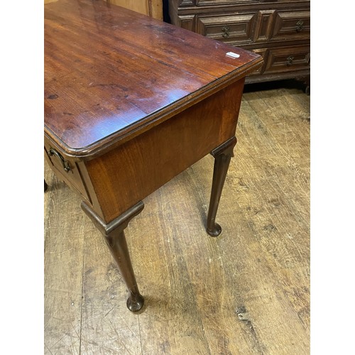 1643 - A 19th century mahogany lowboy, with three drawers, on tapering legs and pad feet, 76 cm wide