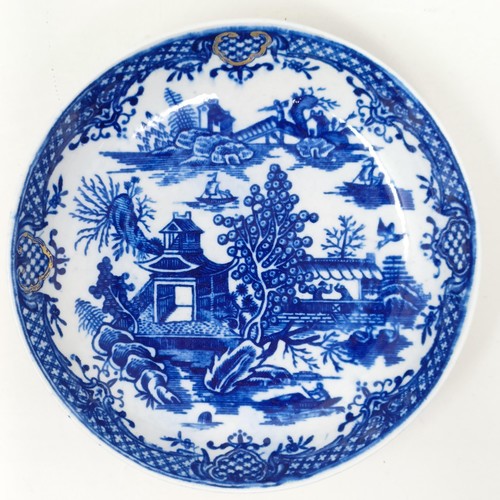 1558 - An 18th/19th century blue and white tea bowl, 17 cm diameter, another, and two saucers (4)