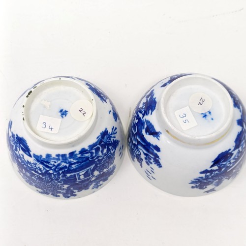 1558 - An 18th/19th century blue and white tea bowl, 17 cm diameter, another, and two saucers (4)