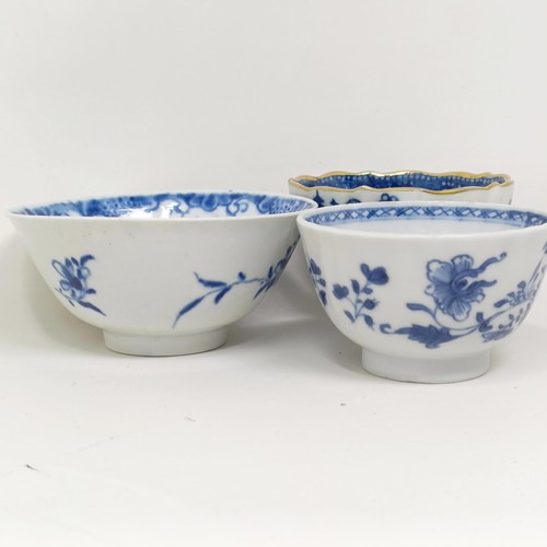 1561 - An 18th/19th century blue and white tea bowl, decorated flowers, diameter 7 cm, and two others (3)