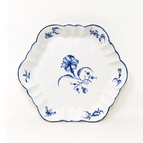 1566 - An 18th century blue and white shaped dish, decorated flowers, W mark to base, 13 cm diameter