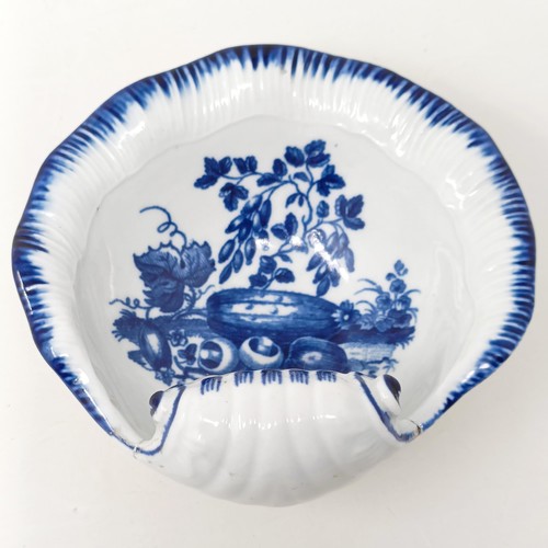 1568 - An early Worcester blue and white shell form bowl, decorated still life of fruit, crescent moon mark... 