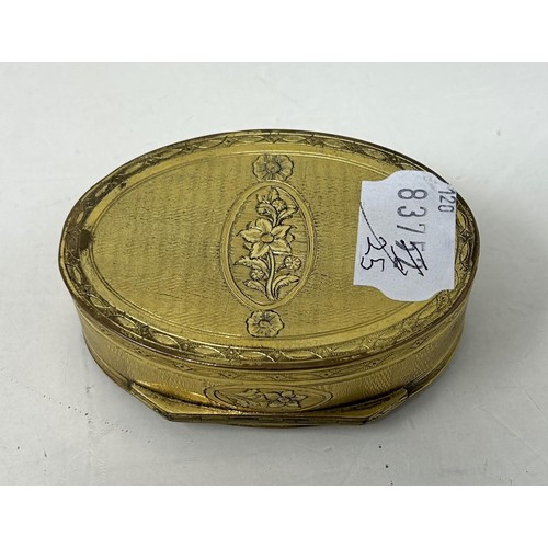 1521 - A gilt metal oval box, the top inset with a blue hardstone plaque, 8 cm wide