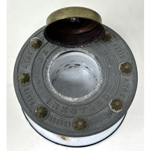 1530 - A 19th century porcelain and brass inkstand, A T & C patent, decorated flowers, 9 cm diameter