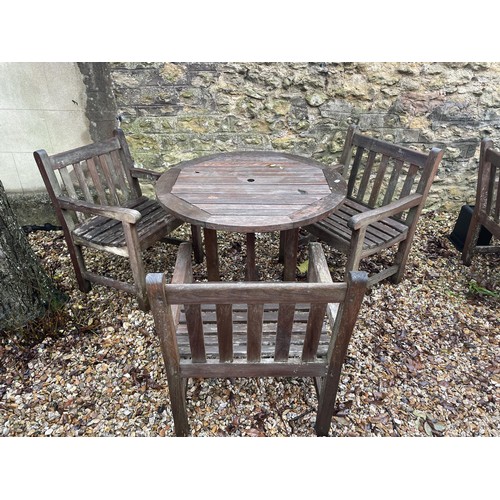 1746 - A teak garden table, 90 cm diameter, and three chairs (4)