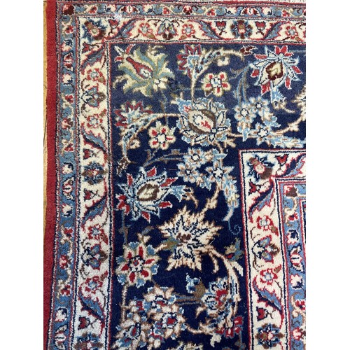 1742 - A Persian style red ground carpet, 390 x 297 cm