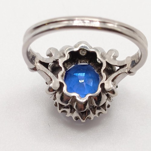 955 - A diamond and blue gem cluster ring