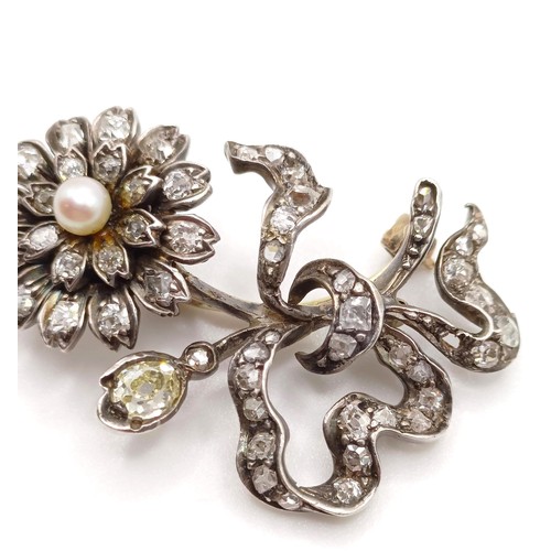 961 - An early 20th century diamond and pearl floral brooch